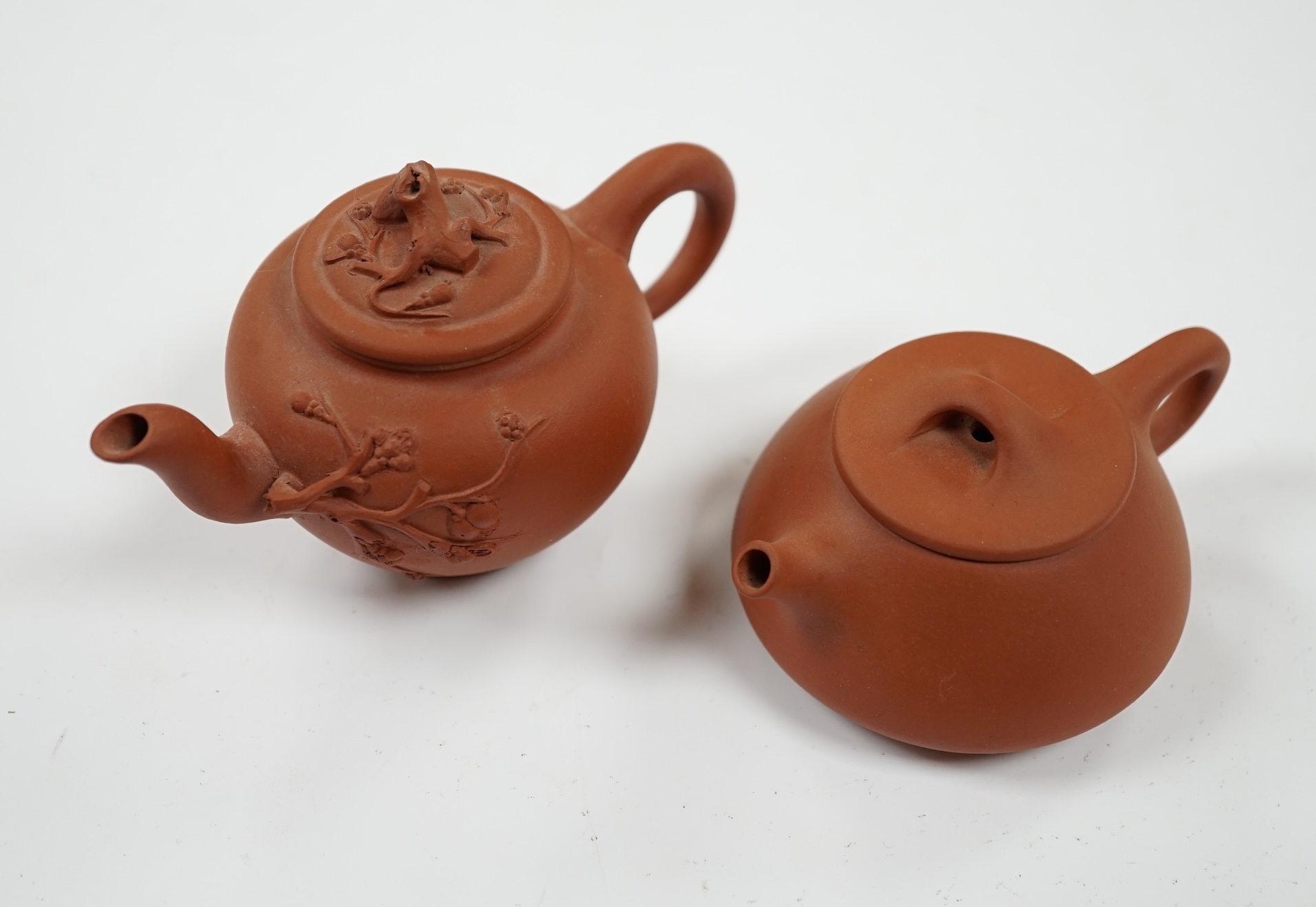 Two Chinese Yixing miniature teapots, largest 11.5cm wide. Condition - good